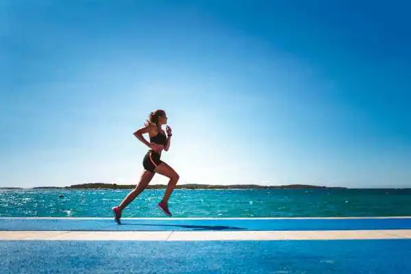 Woman running showing strong leg muscle Warfield